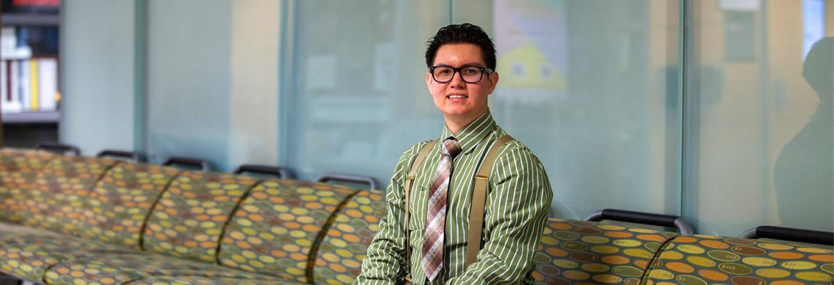 Nicolas Fimbres sits smiling at Pima West Campus