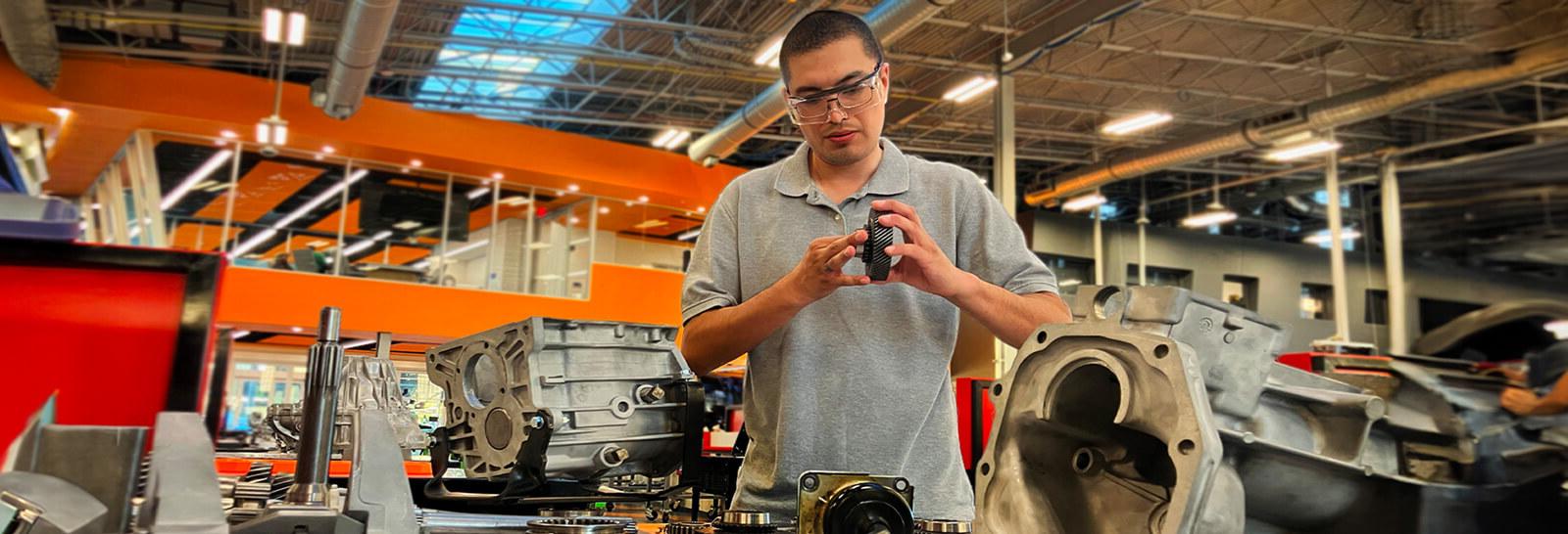 Fernando Romera works on an engine at Pima's Automotive Technology center.